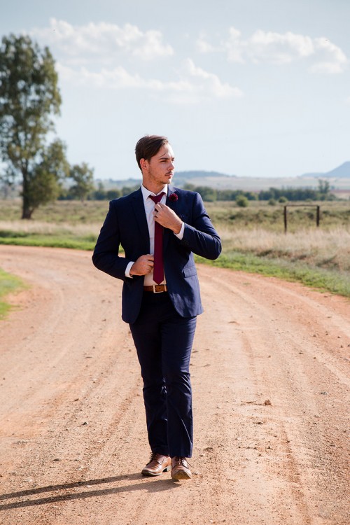wedding photography of groom walking and looking around photo by unix photography Bloemfontein photographer wedding photography groom walking and looking around