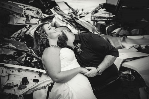 scrapyard theme bridal shoot groom kissing bride in neck photo by Unix photography Wedding photography scrapyard theme bridal shoot groom kissing bride in neck photo by Bloemfontein photographer Unix photography